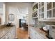 A convenient butler's pantry featuring granite countertops and white cabinetry at 5170 Pinyon Jay Rd, Parker, CO 80134