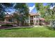 Charming home with stone accents, manicured lawn, and mature trees on a sunny day at 5170 Pinyon Jay Rd, Parker, CO 80134