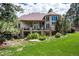 Back exterior view of the house, showing backyard, balconies, and lush surroundings at 5170 Pinyon Jay Rd, Parker, CO 80134