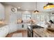 Well-lit kitchen with granite island, updated appliances, and ample counter space at 5170 Pinyon Jay Rd, Parker, CO 80134