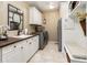 Functional laundry room with sink, wood counters, cabinetry, and stainless steel appliances at 5170 Pinyon Jay Rd, Parker, CO 80134