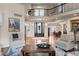 Spacious living room with hardwood floors, high ceilings, and abundant natural light at 5170 Pinyon Jay Rd, Parker, CO 80134