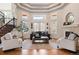 Comfortable living room features coffered ceilings, a fireplace and ample natural light at 5170 Pinyon Jay Rd, Parker, CO 80134