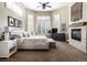 Spacious main bedroom featuring a fireplace, large windows, and a ceiling fan at 5170 Pinyon Jay Rd, Parker, CO 80134
