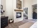 Main bedroom with a fireplace, dresser and doorway to an ensuite bath at 5170 Pinyon Jay Rd, Parker, CO 80134