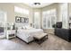 Bright main bedroom with large windows, neutral decor, and comfortable furnishings at 5170 Pinyon Jay Rd, Parker, CO 80134