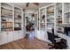 Spacious office with custom shelving and storage, with a view into the home at 5170 Pinyon Jay Rd, Parker, CO 80134