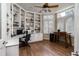 Bright office space with custom built-in shelving, hardwood floors, and natural light at 5170 Pinyon Jay Rd, Parker, CO 80134