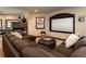 Enjoy movie nights in this cozy theater room with a fireplace and large screen at 5170 Pinyon Jay Rd, Parker, CO 80134