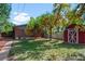 Expansive backyard featuring a shed, a well-manicured lawn, and mature trees, creating a serene outdoor space at 4585 S Elati St, Englewood, CO 80110