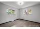 Bright bedroom features two windows, wood flooring, neutral walls and modern lighting at 4585 S Elati St, Englewood, CO 80110