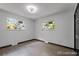 Light and airy bedroom with modern lighting, neutral walls, two windows, and sleek wood flooring at 4585 S Elati St, Englewood, CO 80110