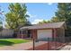 Lovely single Gathering home with a manicured lawn, attached garage, and classic brick exterior at 4585 S Elati St, Englewood, CO 80110