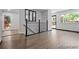 Bright foyer with hardwood floors, black iron stair railings, and a view to the front door at 4585 S Elati St, Englewood, CO 80110