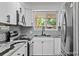 Well-lit kitchen featuring stainless steel appliances, a modern backsplash, and granite countertops, offering both style and functionality at 4585 S Elati St, Englewood, CO 80110