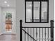 Stylish staircase leading to a bright, modern kitchen with new appliances and cabinetry at 4585 S Elati St, Englewood, CO 80110