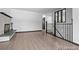 An open living room with wood flooring, a marble fireplace, and a staircase with black railings at 4585 S Elati St, Englewood, CO 80110