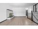 Contemporary living room featuring sleek hardwood floors and a stylish corner marble fireplace at 4585 S Elati St, Englewood, CO 80110