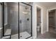 Modern bathroom featuring a glass-enclosed shower with gray tile and a built-in seat and black trim at 2078 S Holly St # 2, Denver, CO 80222