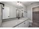 Bright bathroom with a gray countertop, modern black hardware, and a walk-in shower in the background at 2078 S Holly St # 2, Denver, CO 80222