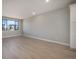 Living room with light hardwood floors, a bright window and neutral paint at 2078 S Holly St # 2, Denver, CO 80222