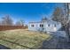 Well-kept backyard with a charming blue house and white trim, perfect for relaxation and gatherings at 7100 E 5Th Ave, Denver, CO 80220