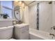 Updated bathroom featuring marble surround and modern vanity at 7100 E 5Th Ave, Denver, CO 80220