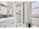 Contemporary bathroom featuring sleek vanity, glass-enclosed shower, and modern fixtures at 7100 E 5Th Ave, Denver, CO 80220