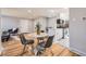 Open floor plan with modern dining area adjacent to a kitchen featuring stylish finishes and fixtures at 7100 E 5Th Ave, Denver, CO 80220