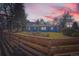 Charming blue home featuring a well-maintained lawn and rustic wood fence, ideal for suburban living at 7100 E 5Th Ave, Denver, CO 80220
