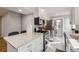 Updated kitchen features stainless steel appliances, light countertops, and mosaic backsplash at 7100 E 5Th Ave, Denver, CO 80220