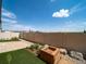 Landscaped backyard featuring artificial turf, paving stones, and a wood planter box, perfect for outdoor enjoyment at 21927 E 51St Dr, Aurora, CO 80019