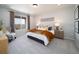Bright bedroom featuring a large window, neutral decor and an inviting bed with decorative pillows and velvet throw at 21927 E 51St Dr, Aurora, CO 80019