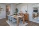 Elegant dining room with modern decor, a wood table, and seamless access to the living area at 21927 E 51St Dr, Aurora, CO 80019