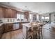 Contemporary kitchen with stainless steel appliances, a breakfast bar, and an open view to the living area at 21927 E 51St Dr, Aurora, CO 80019