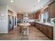 Modern kitchen with stainless steel appliances, center island, wooden cabinets, and sleek countertops at 21927 E 51St Dr, Aurora, CO 80019
