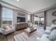 Inviting living room featuring stylish furniture, a modern TV console, and large windows for natural light at 21927 E 51St Dr, Aurora, CO 80019