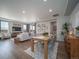 Open-concept living space with dining area, modern decor, hardwood floors, and abundant natural light at 21927 E 51St Dr, Aurora, CO 80019