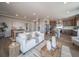 Expansive living space with a comfortable sofa and views of both the dining area and well-equipped kitchen at 21927 E 51St Dr, Aurora, CO 80019