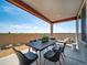 Covered outdoor patio with a dining table and chairs, perfect for al fresco dining and entertaining guests at 21927 E 51St Dr, Aurora, CO 80019