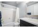 Bathroom with shower and tub combination features modern finishes and a black vanity at 2490 S Worchester Ct # E, Aurora, CO 80014