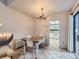 Inviting dining room adjacent to the kitchen with a rustic table and charming chandelier at 2490 S Worchester Ct # E, Aurora, CO 80014