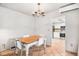 Bright dining area with chandelier lighting and tile floors, leading to a modern kitchen at 2490 S Worchester Ct # E, Aurora, CO 80014