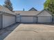 A multi-car garage with neutral paint, trim and roof under a bright blue sky at 2490 S Worchester Ct # E, Aurora, CO 80014