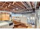 Bedroom with exposed wood ceiling, hardwood floors, sitting area, and plenty of natural light at 2715 Blake St # 2, Denver, CO 80205