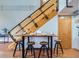 Breakfast table with industrial style staircase, seats three, and a view of coat rack on the adjacent wall at 2715 Blake St # 2, Denver, CO 80205