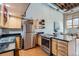 Contemporary kitchen features stainless steel refrigerator, range, and wine rack with black countertops at 2715 Blake St # 2, Denver, CO 80205