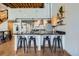 Kitchen with granite countertops and island featuring bar stool seating, wine rack, and shelving at 2715 Blake St # 2, Denver, CO 80205