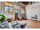 Sunlit living room with desk area featuring industrial-chic accents, providing a unique workspace at 2715 Blake St # 2, Denver, CO 80205