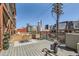A rooftop deck with seating, outdoor rug, potted plants and views of the city at 2715 Blake St # 2, Denver, CO 80205